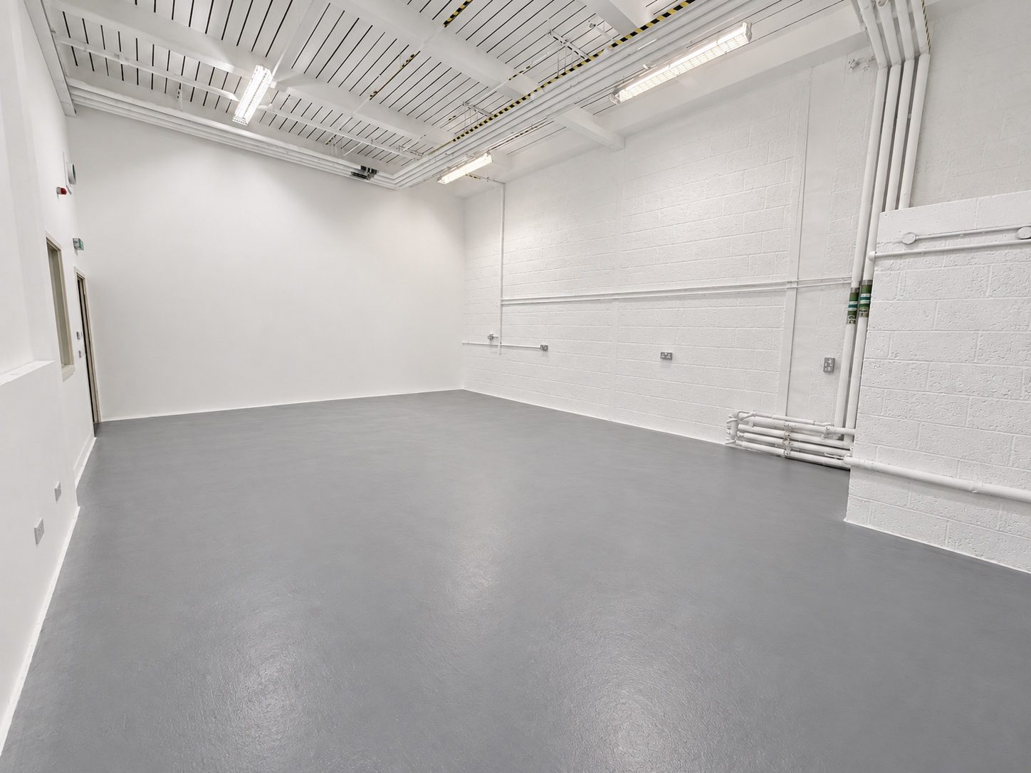 Studio 2 empty, white walls and grey floor